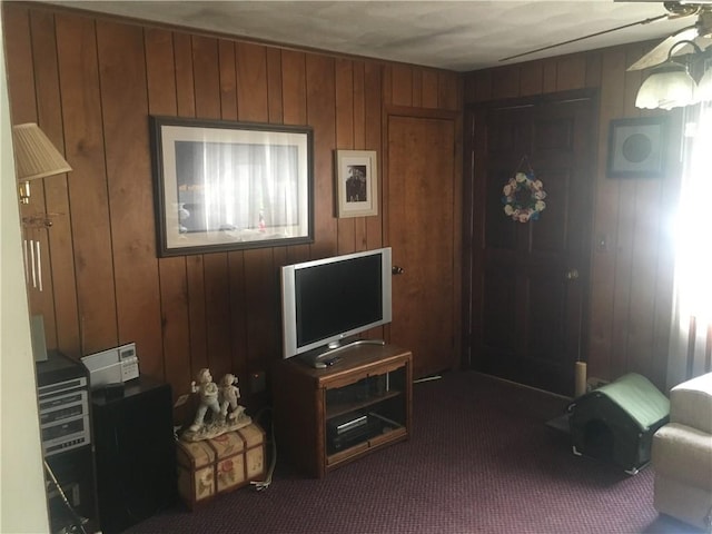 17 Woodcliff Ave, North Providence, RI 02911 - living room with dark carpet, wood walls, and ceiling fan