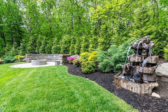 26 Ivy Hollow Ct, Cranston, RI 02921 - view of green lawn featuring an outdoor fire pit and a view of trees