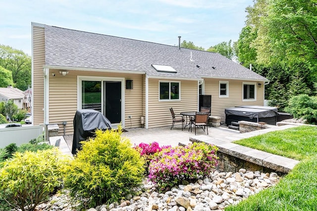 26 Ivy Hollow Ct, Cranston, RI 02921 - rear view of house featuring a hot tub, a shingled roof, and a patio area