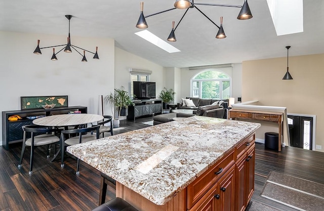 26 Ivy Hollow Ct, Cranston, RI 02921 - kitchen featuring a skylight, a kitchen island, dark wood-style floors, decorative light fixtures, and lofted ceiling