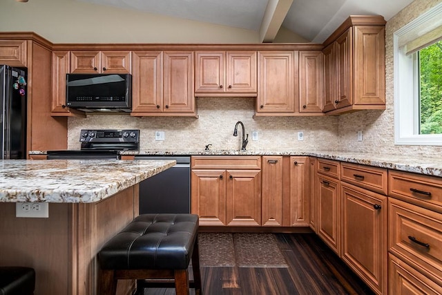 26 Ivy Hollow Ct, Cranston, RI 02921 - kitchen with black appliances, vaulted ceiling, light stone counters, a sink, and decorative backsplash