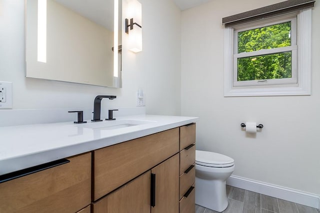 26 Ivy Hollow Ct, Cranston, RI 02921 - bathroom with toilet, vanity, baseboards, and wood finished floors