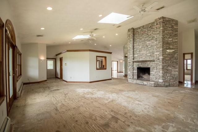 3622 Main Rd, Tiverton, RI 02878 - unfurnished living room featuring ceiling fan, a baseboard heating unit, a skylight, a stone fireplace, and recessed lighting