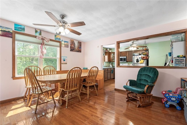 607 Brookhaven Ln, Woonsocket, RI 02895 - dining space featuring a ceiling fan, wood-type flooring, baseboards, and a textured ceiling