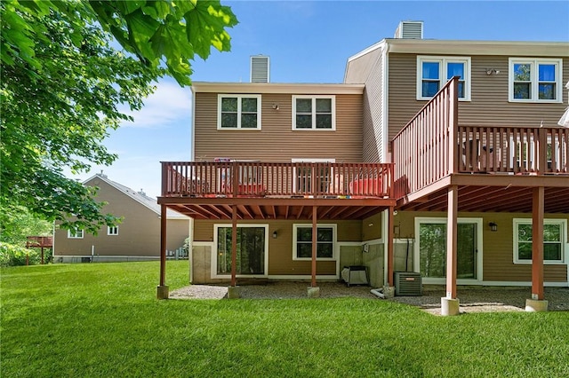 607 Brookhaven Ln, Woonsocket, RI 02895 - back of property featuring a chimney, central AC unit, a yard, and a deck