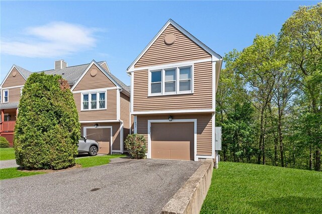 607 Brookhaven Ln, Woonsocket, RI 02895 - view of front of house featuring an attached garage, driveway, and a front lawn