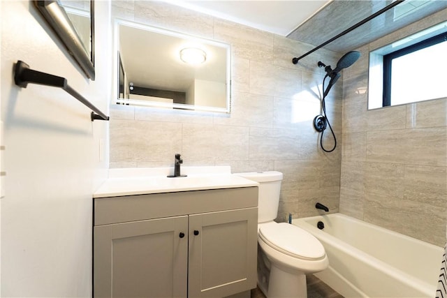76 Park St Unit C1, Pawtucket, RI 02860 - bathroom with tile walls, toilet, tub / shower combination, vanity, and tasteful backsplash