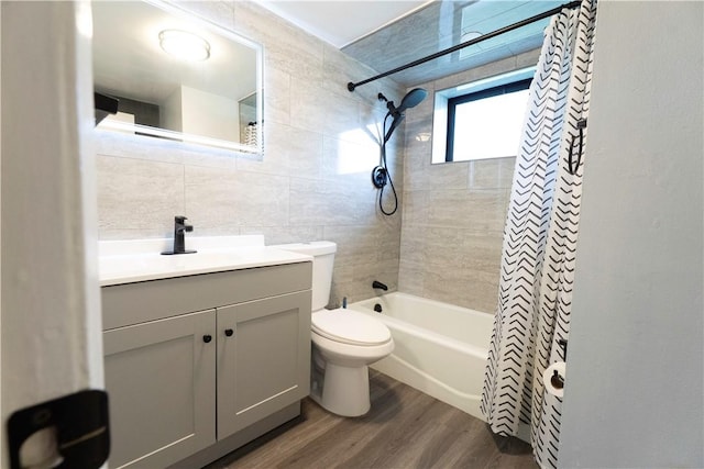 76 Park St Unit C1, Pawtucket, RI 02860 - bathroom with wood finished floors, tile walls, toilet, vanity, and shower / bath combination with curtain