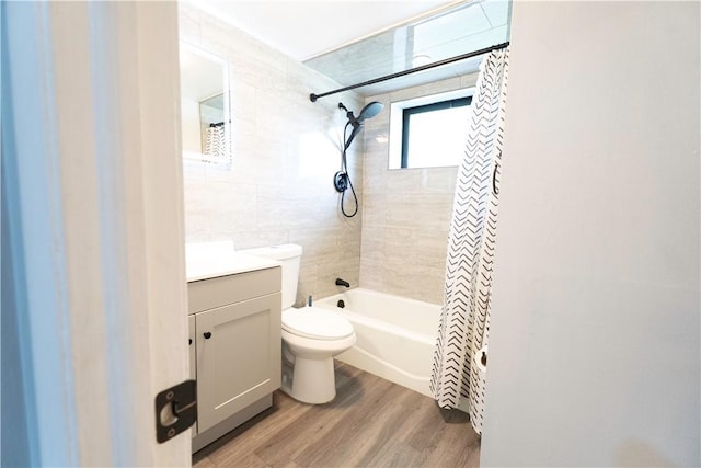 76 Park St Unit C1, Pawtucket, RI 02860 - full bathroom featuring wood finished floors, vanity, toilet, tile walls, and shower / bathtub combination with curtain