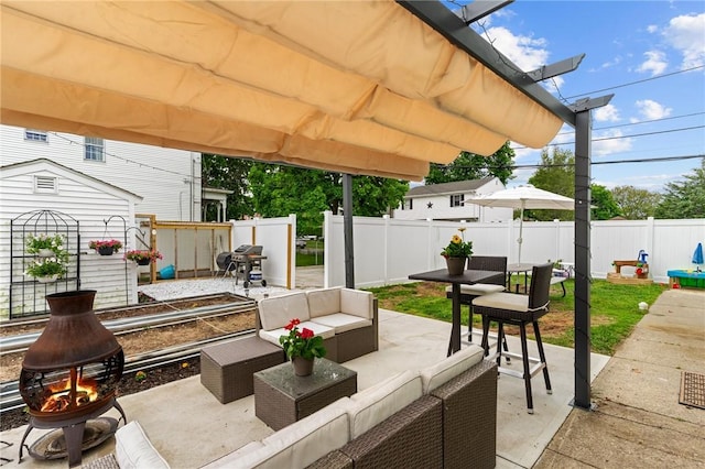 261 Columbus Ave, Pawtucket, RI 02861 - fenced backyard with an outdoor living space with a fire pit, a patio area, and a grill