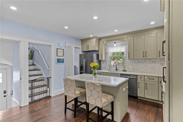 261 Columbus Ave, Pawtucket, RI 02861 - kitchen featuring dishwasher, fridge with ice dispenser, dark wood finished floors, a kitchen island, and a kitchen bar