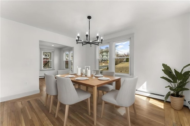 1314 Chalkstone Ave, Providence, RI 02908 - dining room with a chandelier, wood finished floors, baseboard heating, and baseboards