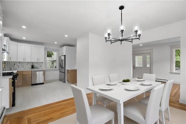 1314 Chalkstone Ave, Providence, RI 02908 - dining room featuring a chandelier, light wood-style flooring, recessed lighting, baseboard heating, and baseboards