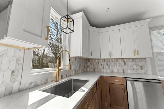 1314 Chalkstone Ave, Providence, RI 02908 - kitchen with stainless steel dishwasher, a sink, light stone counters, tasteful backsplash, and white cabinets