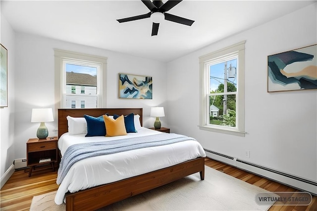 1314 Chalkstone Ave, Providence, RI 02908 - bedroom with a baseboard heating unit, wood finished floors, and a ceiling fan