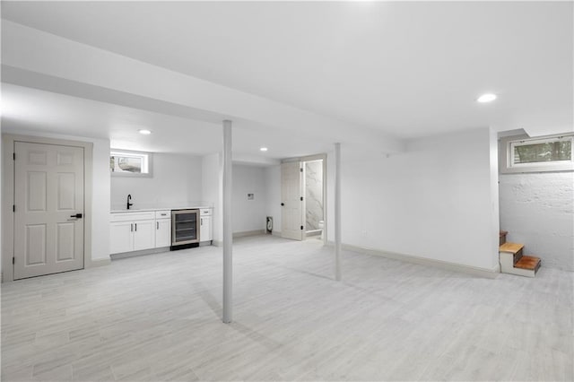 1314 Chalkstone Ave, Providence, RI 02908 - below grade area with wine cooler, bar with sink, stairs, light wood-style floors, and recessed lighting