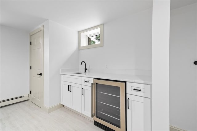 1314 Chalkstone Ave, Providence, RI 02908 - indoor wet bar with beverage cooler, a baseboard heating unit, light wood-style floors, and baseboards