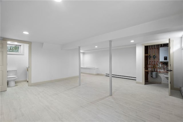 1314 Chalkstone Ave, Providence, RI 02908 - below grade area with a baseboard radiator, recessed lighting, light wood-type flooring, and baseboards