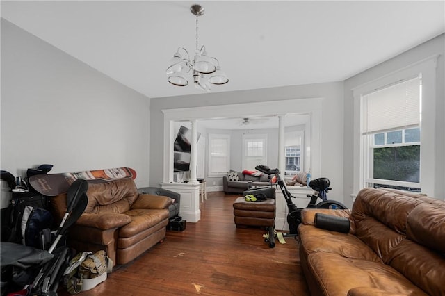 living room featuring dark wood-style flooring and a chandelier