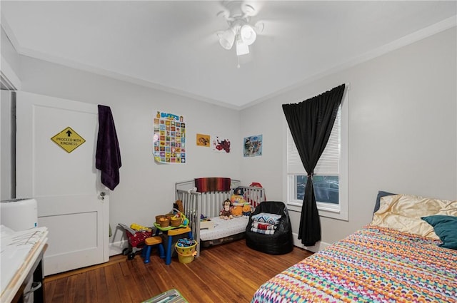 bedroom with wood finished floors and a ceiling fan