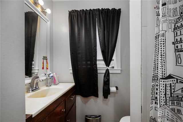 bathroom featuring vanity and toilet