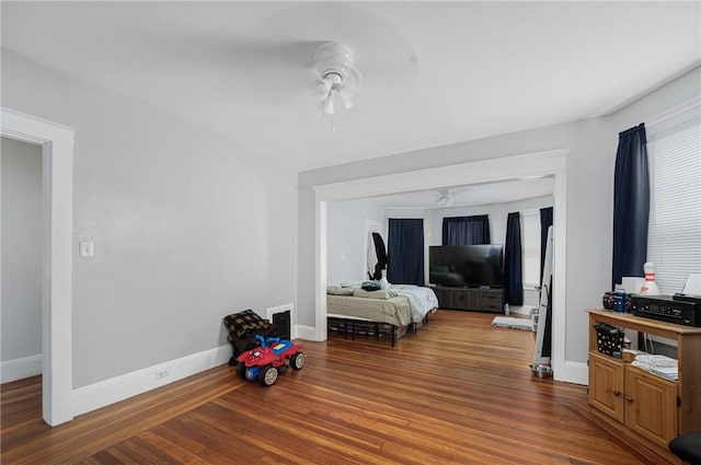 bedroom with baseboards, wood finished floors, and ceiling fan