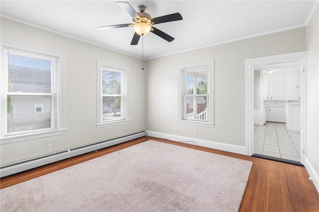 2 Francis St, Coventry, RI 02816 - empty room featuring a baseboard heating unit, wood finished floors, healthy amount of natural light, a ceiling fan, and crown molding