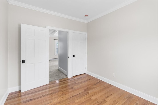 2 Francis St, Coventry, RI 02816 - unfurnished bedroom featuring light wood-style flooring, baseboards, crown molding, and a baseboard radiator