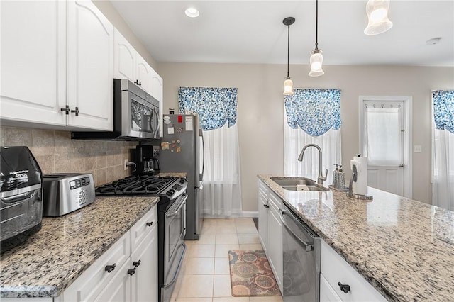2 Francis St, Coventry, RI 02816 - kitchen featuring stainless steel appliances, a sink, decorative backsplash, white cabinetry, and light stone counters