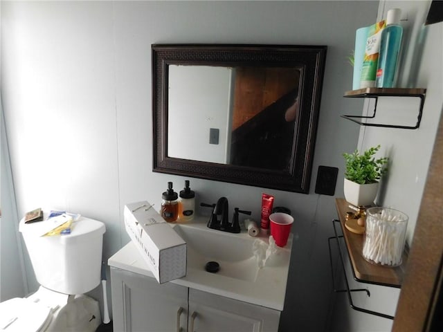 half bath featuring vanity and toilet