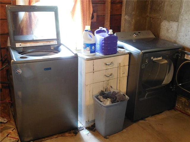 laundry room featuring separate washer and dryer and cabinet space