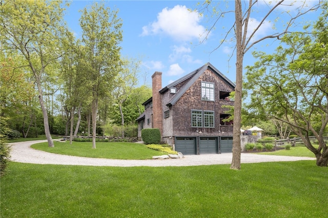 56 Summerfield Ln, Middletown, RI 02842 - view of side of home featuring driveway, a garage, a chimney, and a lawn