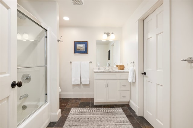 56 Summerfield Ln, Middletown, RI 02842 - bathroom with baseboards, stone tile flooring, vanity, shower / bath combination with glass door, and toilet