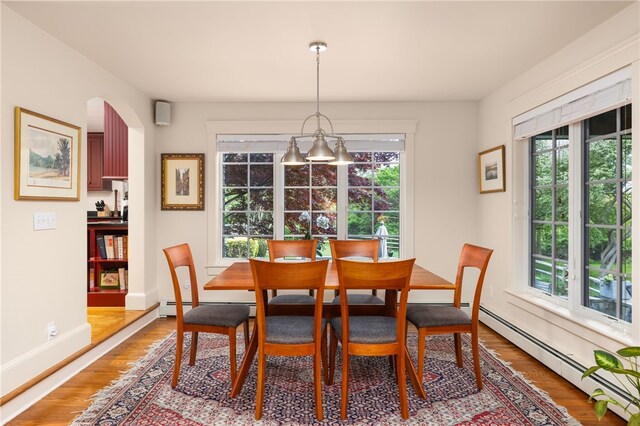 56 Summerfield Ln, Middletown, RI 02842 - dining area with healthy amount of natural light, light wood finished floors, a baseboard heating unit, and baseboards