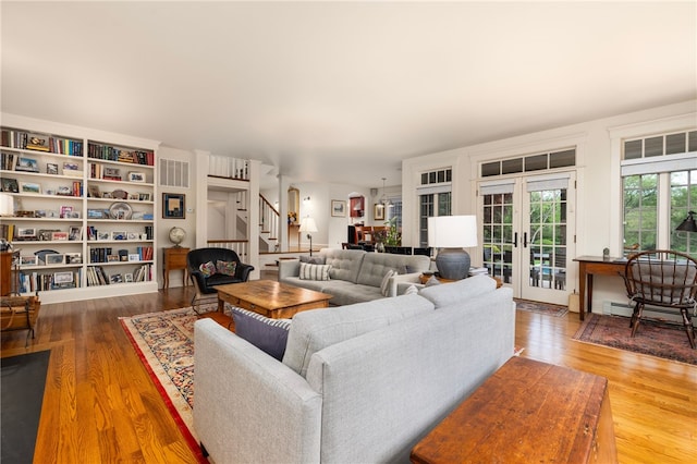 56 Summerfield Ln, Middletown, RI 02842 - living room featuring stairs, wood finished floors, french doors, and a baseboard heating unit