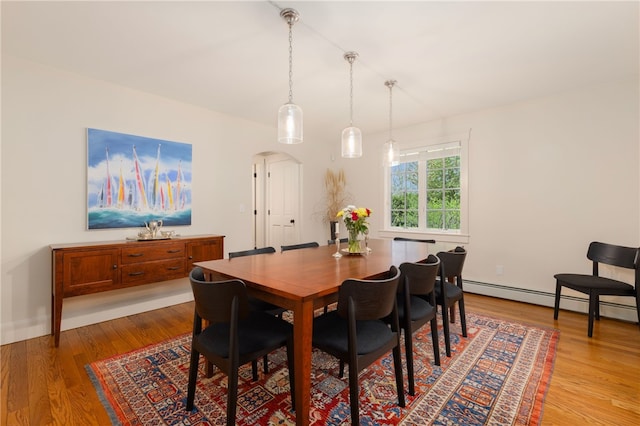 56 Summerfield Ln, Middletown, RI 02842 - dining space featuring light wood-type flooring, a baseboard heating unit, arched walkways, and baseboards