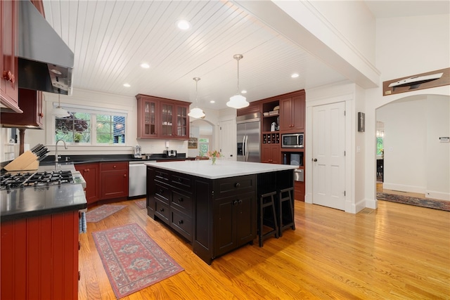 56 Summerfield Ln, Middletown, RI 02842 - kitchen with built in appliances, arched walkways, light wood finished floors, ventilation hood, and recessed lighting