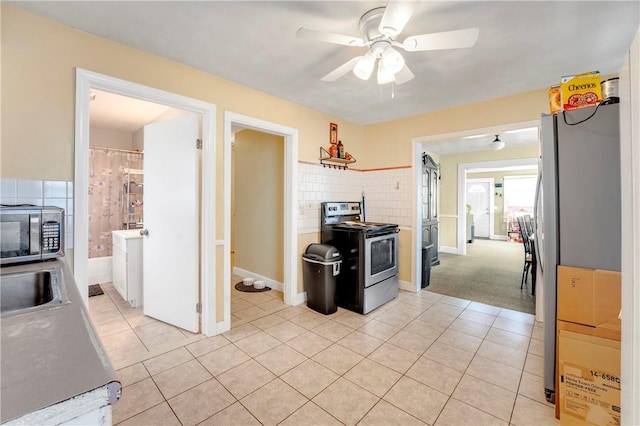 103 Appleton St, Cranston, RI 02910 - kitchen with appliances with stainless steel finishes, a ceiling fan, light tile patterned floors, and baseboards