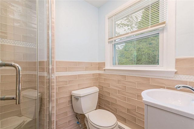 40 Haverhill Ave, North Kingstown, RI 02852 - full bathroom with tile walls, a stall shower, toilet, vanity, and wainscoting
