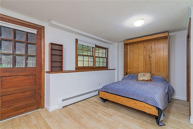 40 Haverhill Ave, North Kingstown, RI 02852 - bedroom featuring a baseboard heating unit, light wood-style floors, ornamental molding, and a textured ceiling
