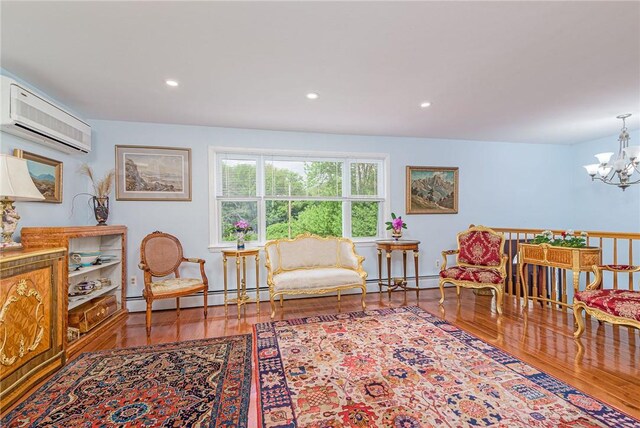 40 Haverhill Ave, North Kingstown, RI 02852 - living area featuring an AC wall unit, a chandelier, wood finished floors, recessed lighting, and a baseboard heating unit