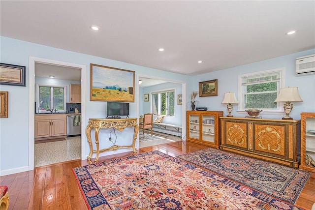 40 Haverhill Ave, North Kingstown, RI 02852 - living area featuring hardwood / wood-style flooring, a wall mounted AC, healthy amount of natural light, and recessed lighting