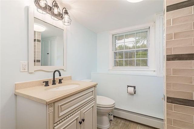 40 Haverhill Ave, North Kingstown, RI 02852 - bathroom with a baseboard heating unit, toilet, vanity, and wood finished floors