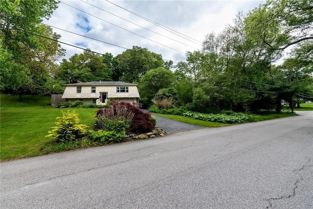 40 Haverhill Ave, North Kingstown, RI 02852 - raised ranch featuring asphalt driveway, a front lawn, an attached garage, and a chimney