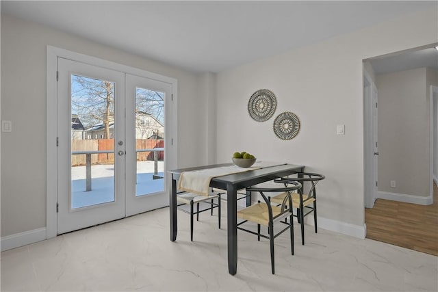 104 Liberty St, Pawtucket, RI 02861 - dining space with french doors, baseboards, and marble look tile flooring