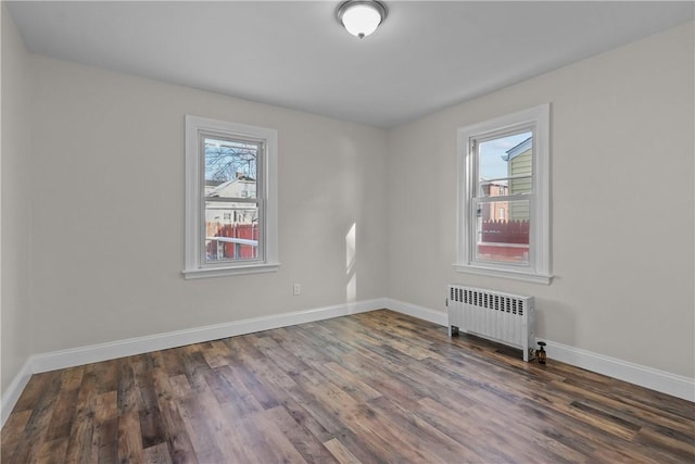 104 Liberty St, Pawtucket, RI 02861 - unfurnished room featuring radiator heating unit, wood finished floors, and baseboards