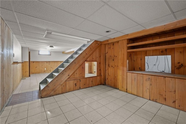 104 Liberty St, Pawtucket, RI 02861 - basement featuring wooden walls, stairway, and a drop ceiling
