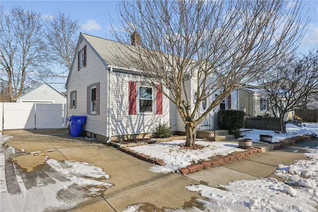 104 Liberty St, Pawtucket, RI 02861 - view of front of house with a chimney, a garage, and a gate