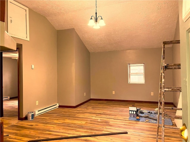 unfurnished living room featuring a baseboard radiator, a textured ceiling, light wood-style flooring, lofted ceiling, and a chandelier