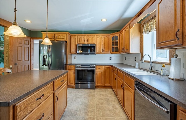 99 Fairfield Ave, Woonsocket, RI 02895 - kitchen featuring appliances with stainless steel finishes, a sink, dark countertops, tasteful backsplash, and recessed lighting